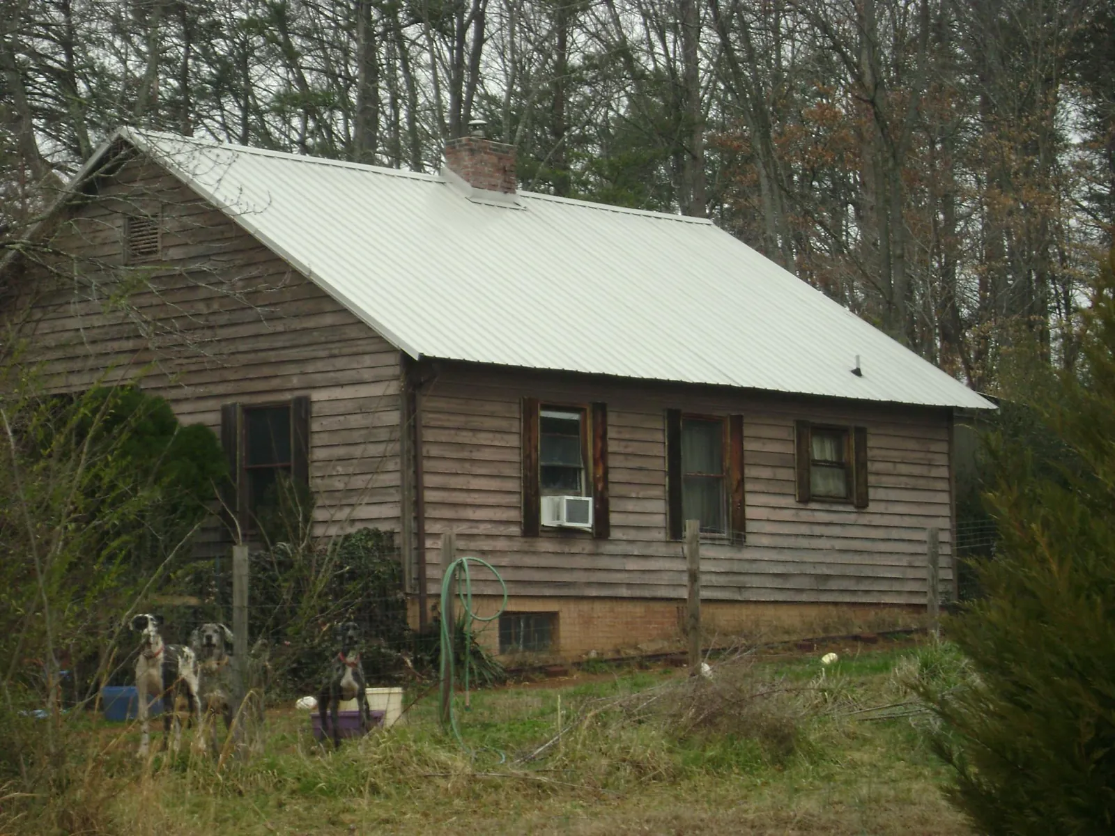 White metal roof on an old wood sided farmhouse, from a Metal Roof Installation job in North Adams